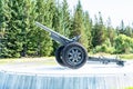 Gronsvik, Norway - August 06, 2019: Side view at artilery gun standing in front of Main building of museum of Gronsvik coastal