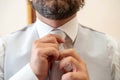 Groom while adjusting his tie Royalty Free Stock Photo