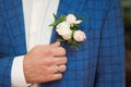 Groom in blue checkered suit with a white and pale pink rose bo Royalty Free Stock Photo