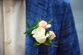 Groom in blue checkered suit with a white and pale pink rose boutonniere, Royalty Free Stock Photo