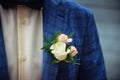 Groom in blue checkered suit with a white and pale pink rose boutonniere Royalty Free Stock Photo