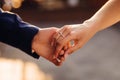 Groom in blue jacket holds tender bride& x27;s hand tightly Royalty Free Stock Photo