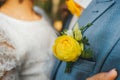 Groom in a blue suit with flower of yellow rose in the pocket of jacket Royalty Free Stock Photo