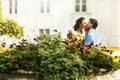 Groom in blue suit kissing a bride in a white dress in the midst Royalty Free Stock Photo