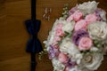 Groom bow tie with bride`s bouquet Royalty Free Stock Photo