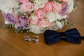 Groom bow tie with bride`s bouquet Royalty Free Stock Photo