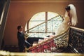 Groom and bride on the background stairs Royalty Free Stock Photo