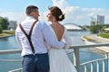 Groom with the bride on the bridge in the city Royalty Free Stock Photo