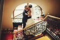 Groom and bride is hugging on the background stairs Royalty Free Stock Photo