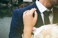 Groom and bride are hugging. Happy wedding couple photo. Romantic photoshoot. White dress with long sleeves. Lace veil Royalty Free Stock Photo