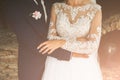 Groom and bride are hugging. Happy wedding couple photo. Romantic photoshoot. White dress with long sleeves. Lace veil Royalty Free Stock Photo