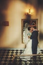 Groom and bride is hugging and kissing on the background miror Royalty Free Stock Photo