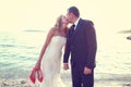 Groom and bride kissing on the beach on a sunny day Royalty Free Stock Photo