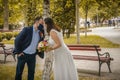 Groom and bride kissing each other in protective medical masks Royalty Free Stock Photo