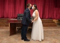 Groom and bride kissing each other in protective medical masks on face in Royalty Free Stock Photo