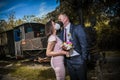 Groom and bride kissing each other in protective medical masks on face in Royalty Free Stock Photo