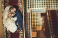 Groom and bride is lying and smiling on the stairs