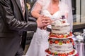 Groom and bride marriage Cutting the delicious fruity Wedding Cake together colorful fruits Royalty Free Stock Photo