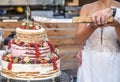 Groom and bride marriage Cutting the delicious fruity Wedding Cake together colorful fruits Royalty Free Stock Photo