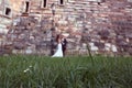Groom and bride near a brick wall Royalty Free Stock Photo