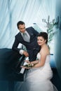 Groom and the bride near a grand piano Royalty Free Stock Photo