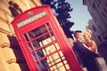 Groom and bride near phonebooth