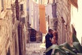 Groom and bride outdoors on a narrow street on their wedding day Royalty Free Stock Photo