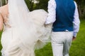 Groom and bride running away Royalty Free Stock Photo