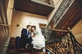 Groom and bride is sitting and hugging on the stairs Royalty Free Stock Photo