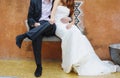 Groom and bride sitting on a bench Royalty Free Stock Photo