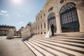 Groom and bride stand on stairs by the great palace in Wiena