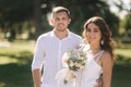 Groom and bride in their wedding day walking in the park. Newlyweds spend time together. Just married Royalty Free Stock Photo