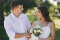 Groom and bride in their wedding day walking in the park. Newlyweds spend time together. Just married Royalty Free Stock Photo