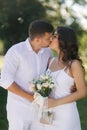 Groom and bride in their wedding day walking in the park. Newlyweds spend time together. Just married Royalty Free Stock Photo