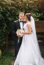 Groom and bride walk in the park on their wedding day. Happy couple spend time together Royalty Free Stock Photo