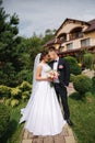 Groom and bride walk in the park on their wedding day. Happy couple spend time together Royalty Free Stock Photo