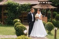 Groom and bride walk in the park on their wedding day. Happy couple spend time together Royalty Free Stock Photo