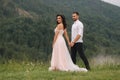 Groom and bride walkin thougt the carpatian mountains Royalty Free Stock Photo
