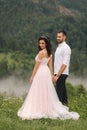 Groom and bride walkin thougt the carpatian mountains Royalty Free Stock Photo