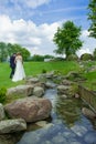 groom and bride walking on the grasss Royalty Free Stock Photo