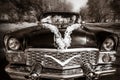 Groom and the bride at a wheel of a black old retro of the car Royalty Free Stock Photo