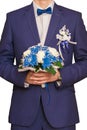 The groom costs with a bouquet on flowers for the bride