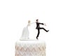 Groom doll and statue is running away but bride can catch him finally. the funny wedding story doll on the top of cake with