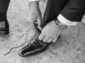 The groom is fastening his wedding shoe Royalty Free Stock Photo