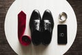 Groom is gathering in the morning.Men's classic shoes, belt,toilette, perfume, leather strap watch, wedding rings Royalty Free Stock Photo