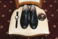 Groom is gathering in the morning.Men& x27;s classic shoes, belt,toilette, perfume, leather strap watch, wedding rings Royalty Free Stock Photo