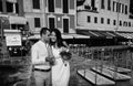 Groom gently embraces the bride near sea