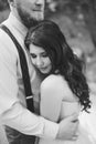 The groom gently hugs the bride, who leaned against his chest and closed her eyes, black and white Royalty Free Stock Photo