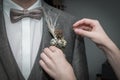 The groom gets a corsage infected by the bride`s mother before a wedding, Germany Royalty Free Stock Photo