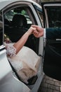 Groom give hands bride out from wedding car Royalty Free Stock Photo